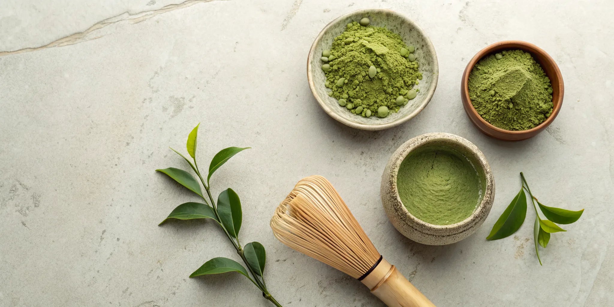 Vibrant green matcha powder in a bowl with a bamboo whisk for a traditional Japanese tea ceremony.